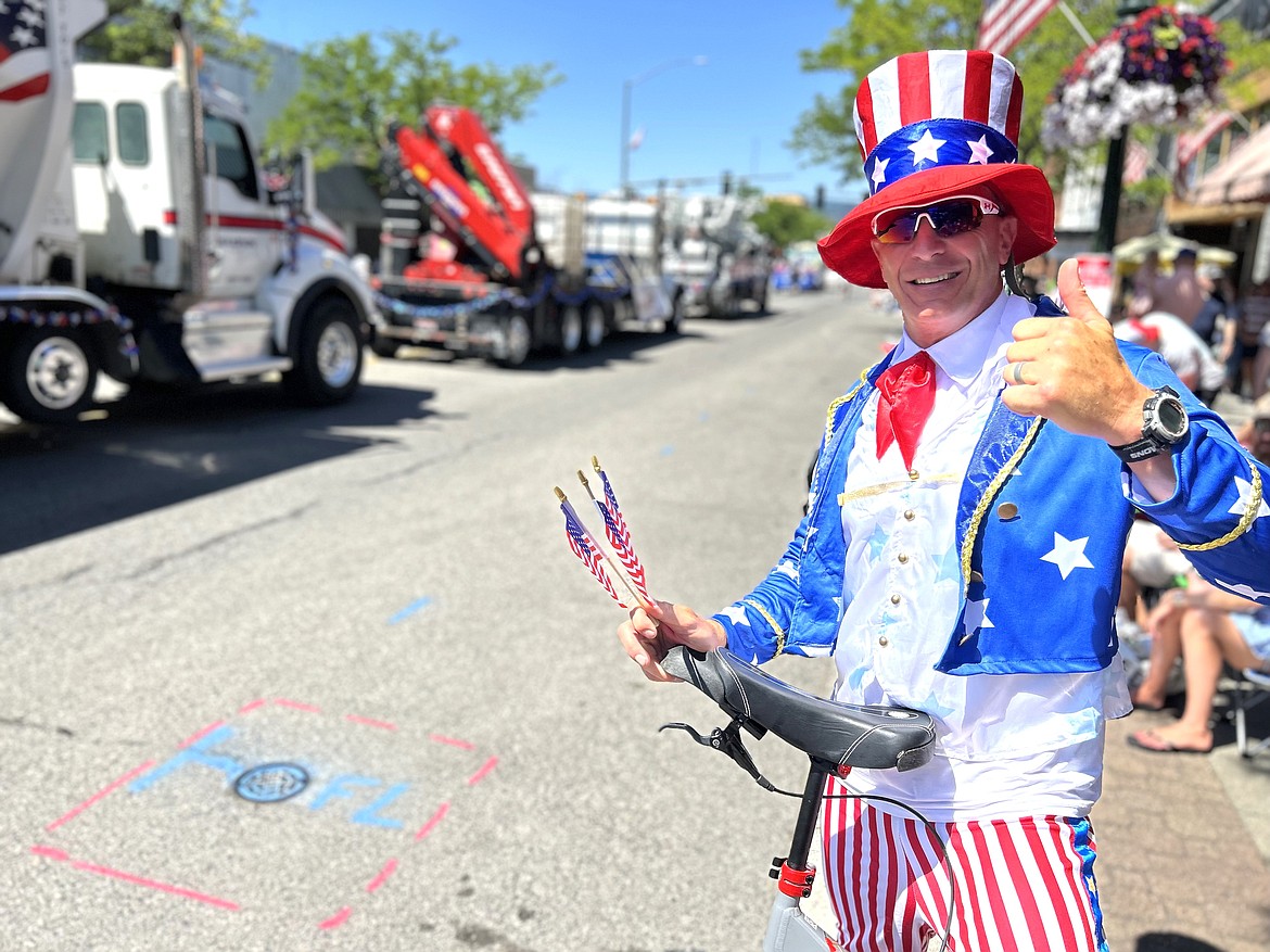 Rod Fuller offers a thumbs up as he stands on the sidelines for a minute during the Fourth of July parade in Coeur d'Alene.