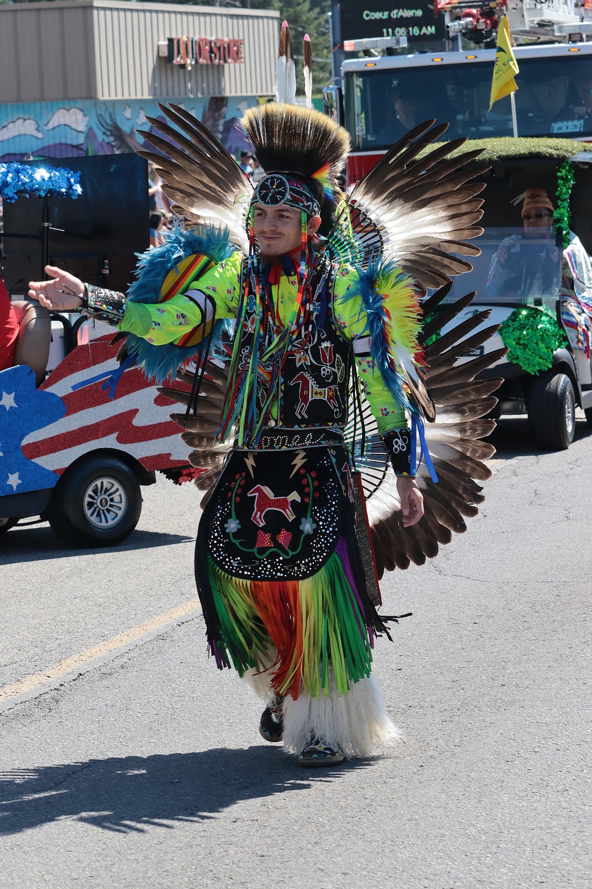 Christian Fulton with the Coeur d'Alene Tribe walks on Sherman Avenue during the parade.