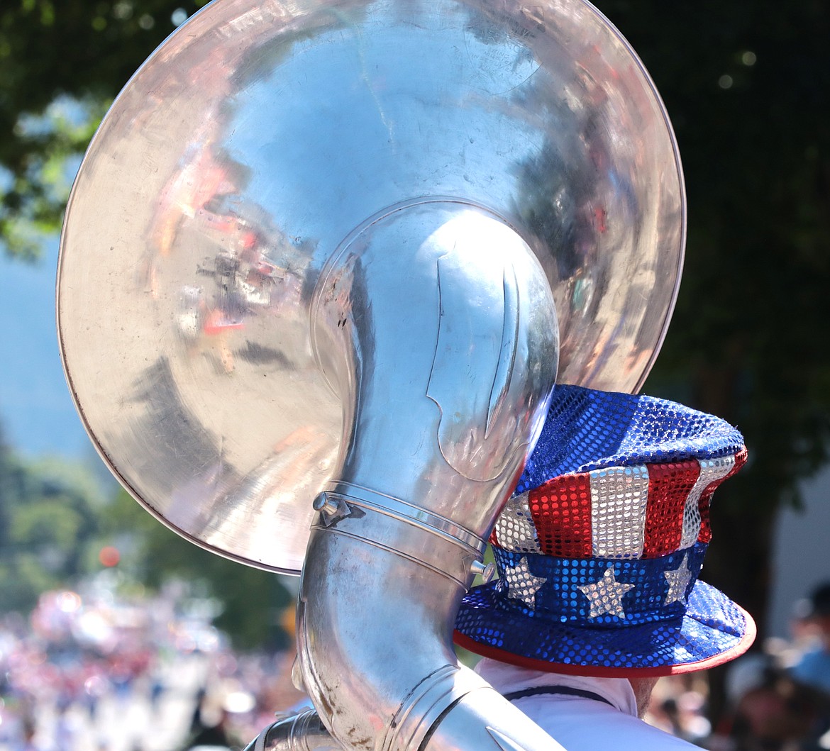 The parade is reflected in a tuba on Thursday.