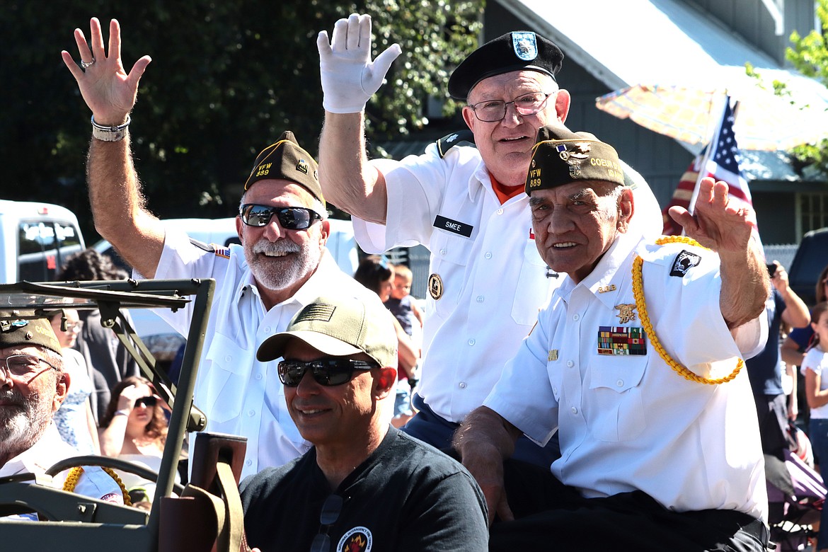 Veterans, from left, Mark Taylor, Bob Smee and Joe Kaczmar wave during Thursday's parade on Sherman Avenue.