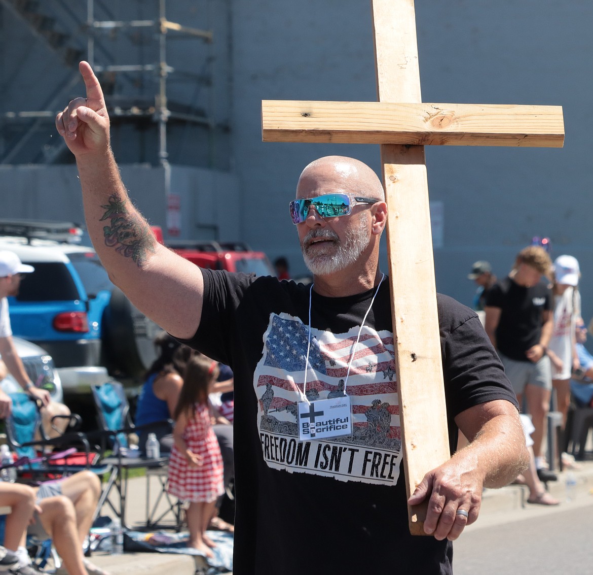 Johnny Hodson carries a cross during the Fourth of July parade.