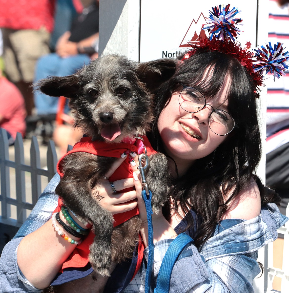 Presley Parisot holds Bella on the Companions Animal Center Fourth of July parade entry.