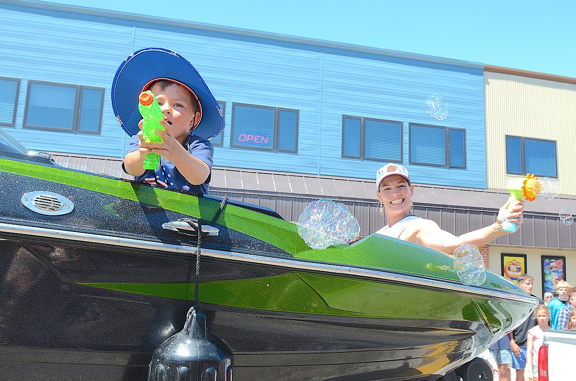 These two parade participants, armed with squirt and bubble guns, were a hit during Polson's parade. (Kristi Niemeyer/Leader)