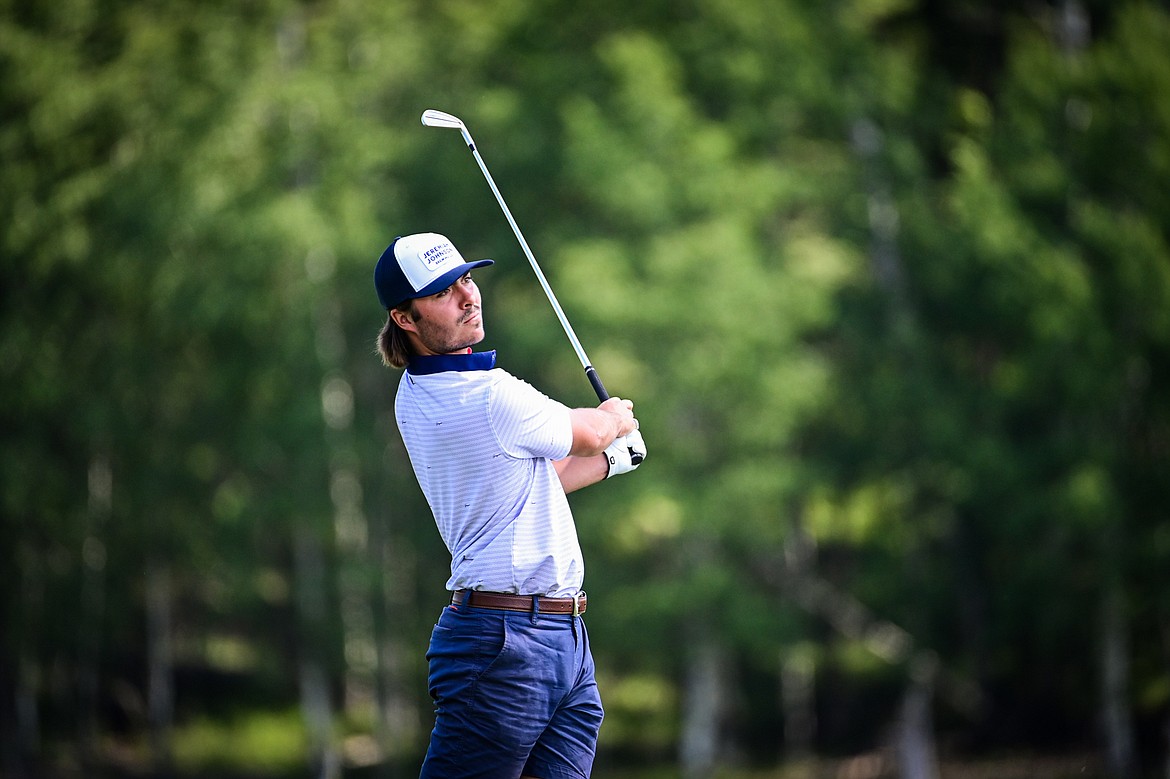 Christian Clark watches his tee shot on the 8th hole of the South Course during the Earl Hunt Memorial 4th of July Tournament at Whitefish Lake Golf Club on Friday, July 5. (Casey Kreider/Daily Inter Lake)