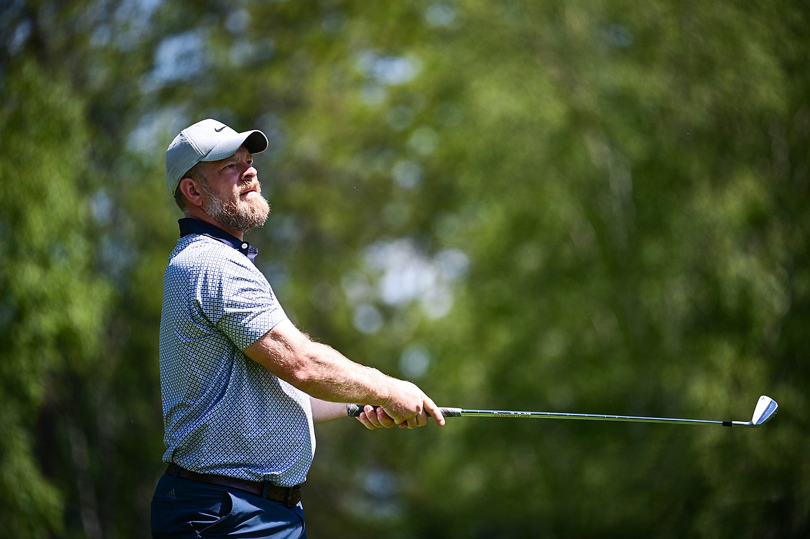 Justin Dorr watches his tee shot on the 15th hole of the South Course during the Earl Hunt Memorial 4th of July Tournament at Whitefish Lake Golf Club on Friday, July 5. (Casey Kreider/Daily Inter Lake)