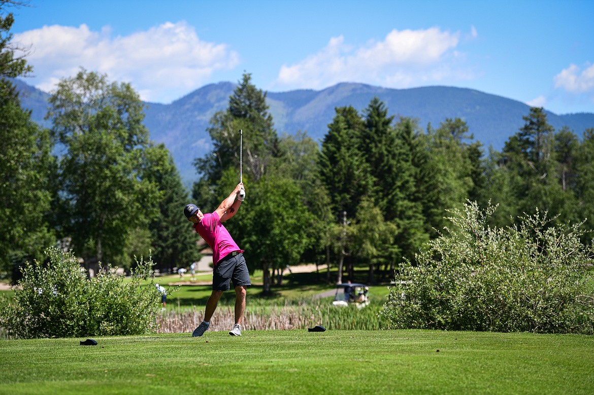 Liam Clancy watches his tee shot on the 7th hole of the South Course during the Earl Hunt Memorial 4th of July Tournament at Whitefish Lake Golf Club on Friday, July 5. (Casey Kreider/Daily Inter Lake)