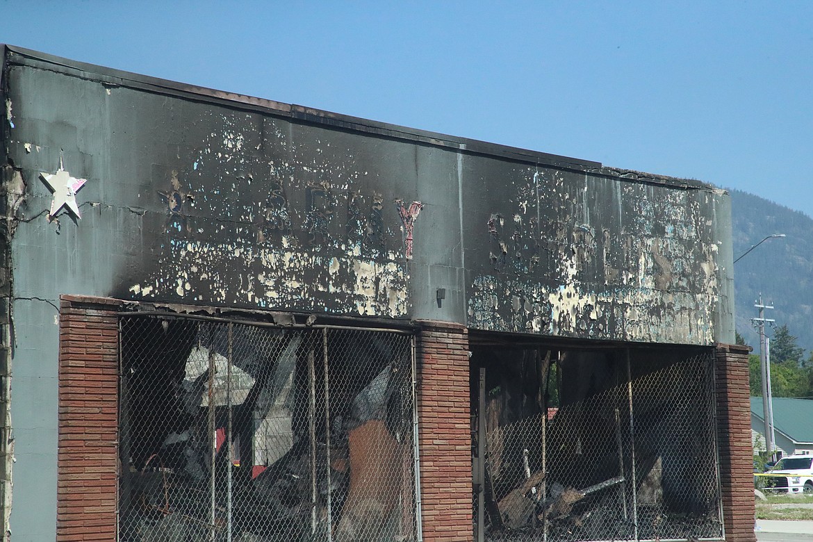 The faint outline of Army Surplus can just be seen on what remains of the building Friday morning after the business was destroyed in a July 4 fire. The cause of the fire is unknown and an investigation is underway.