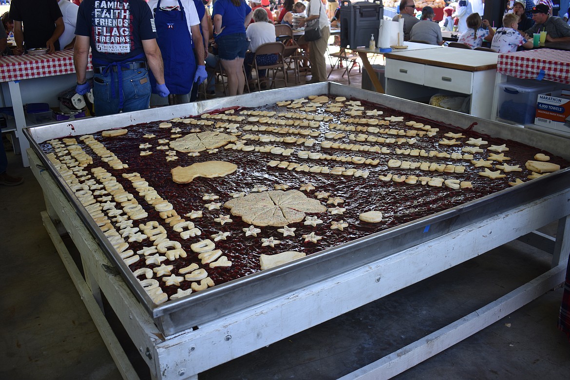 A traditional part of George’s Independence Day celebration, the enormous cherry pie waits to be cut and served to the crowd.