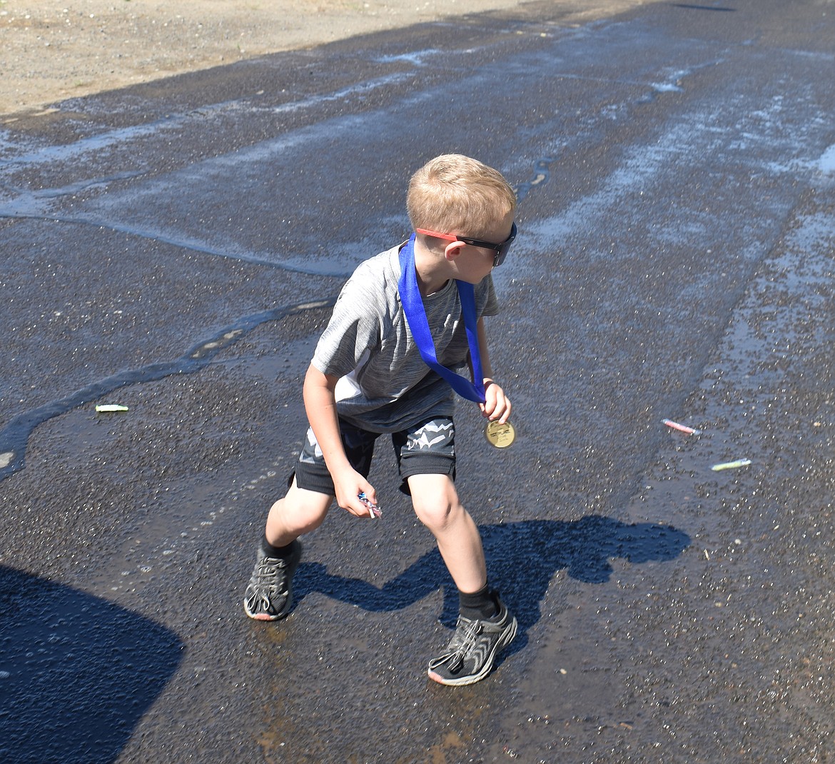 Oscar Pedeferri, 6, looks around for more candy at the Fourth of July parade in George Thursday morning.