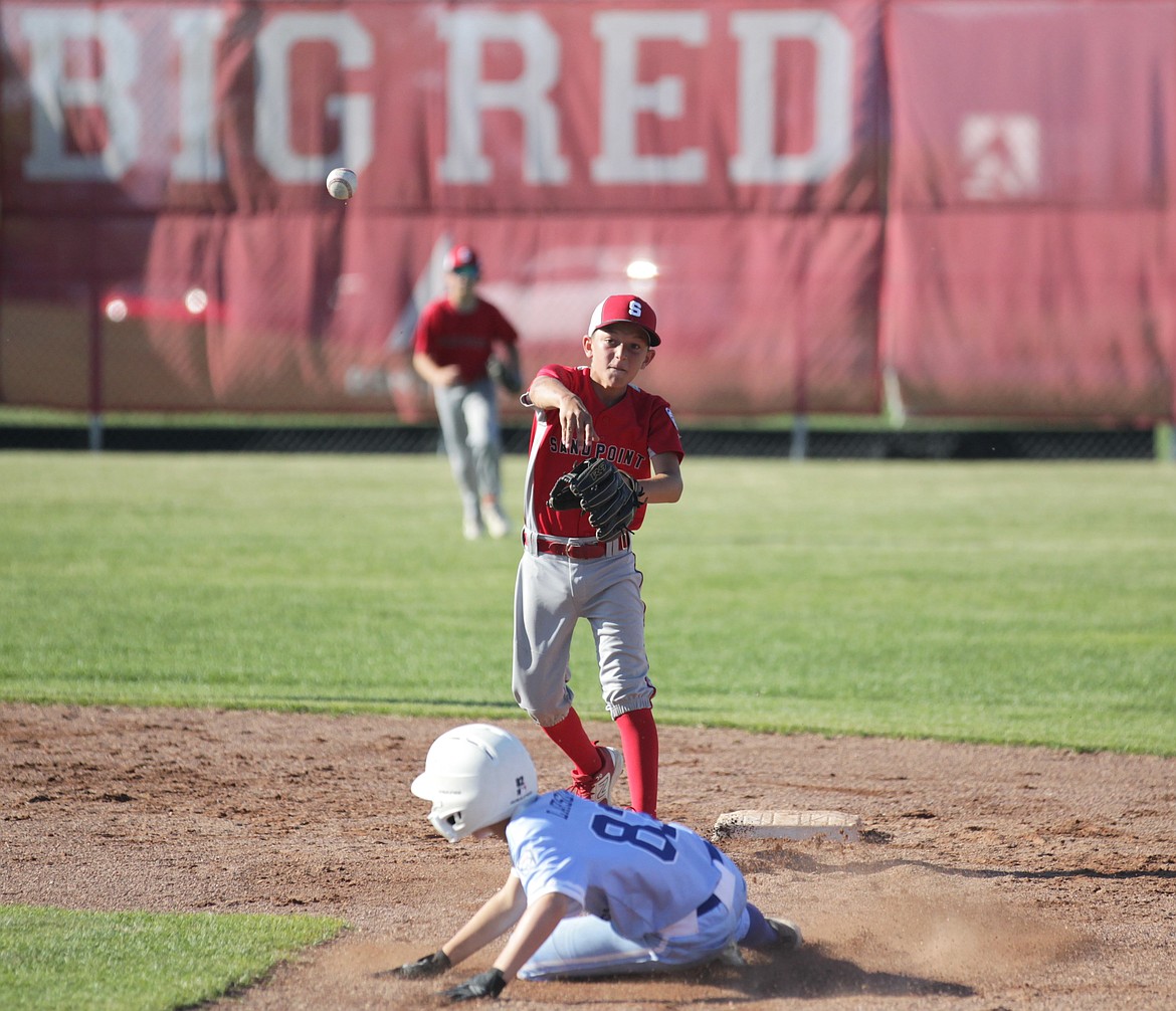 MARK NELKE/Press
Sandpoint shortstop Cruz Oliver throws over Coeur d'Alene runner Kellan Larson to first base for the double play Saturday in a Little League (12U) District 1 tournament game at Croffoot Park in Hayden.