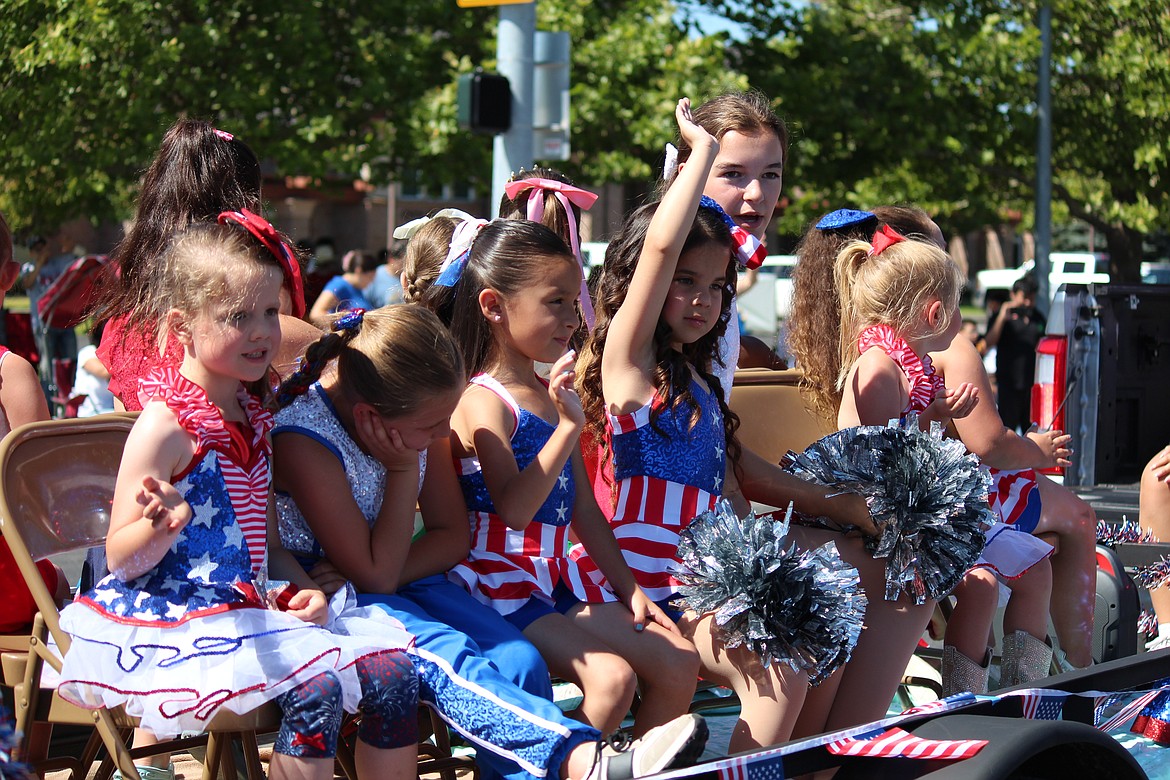 Participants wave to the crowd during the July 4 parade down Main Street in Othello.