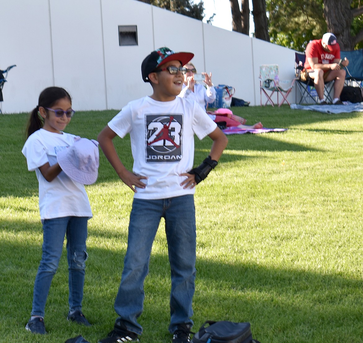 Eight-year-old Sinead Estrada, left, and her brother Brandon Estrada, 10, watch the stage expectantly before the concert at Red, White and Boom Wednesday.