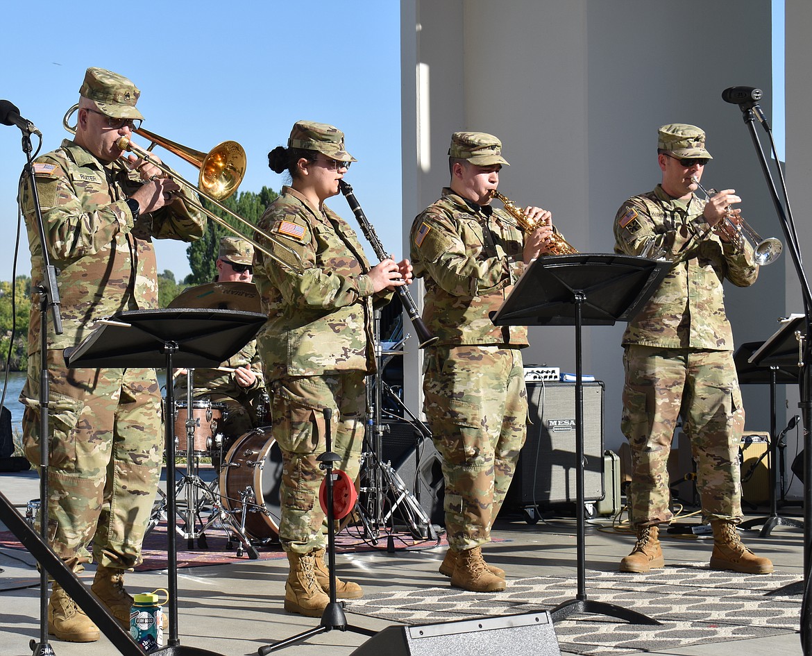 Members of the 133d Washington National Guard Band get ready for the band’s performance at Red, White and Boom Wednesday at McCosh Park.