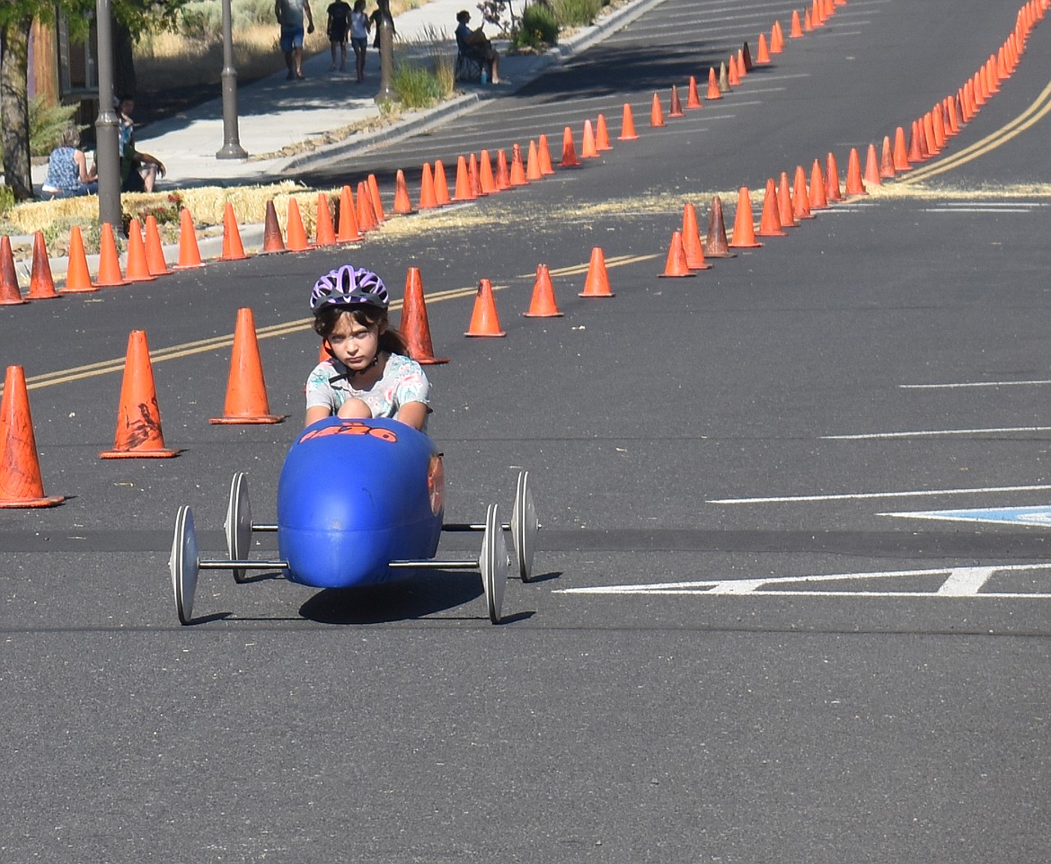 Isla Fortner, 10, steers her Soap Box Derby car to the finish line during a practice run Saturday morning. She was one of 11 young drivers competing at the derby, which was part of Soap Lake’s Suds ‘N Sun celebration.