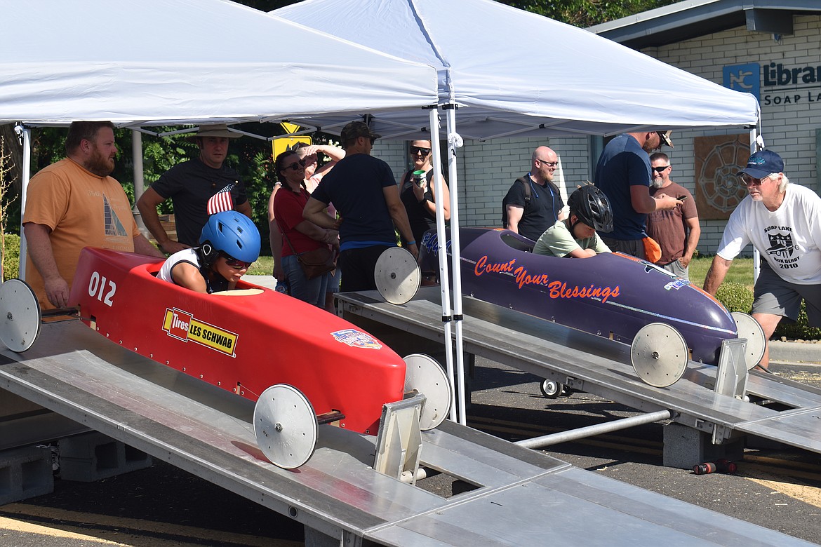 Two drivers get ready to roll at the Soap Lake Suds ‘N Sun Soap Box Derby Saturday. The derby began at the top of the hill on East Main Avenue by the library and finished up at Canna Street about 1,000 feet away.