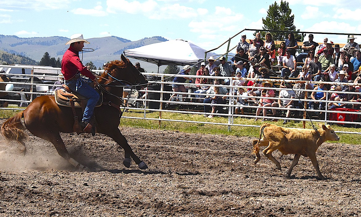 Hot Springs cowboy Jack McAllister ropes his calf in the tie-down roping at the Arlee Rodeo on the Fourth of July. (Berl Tiskus/Leader)