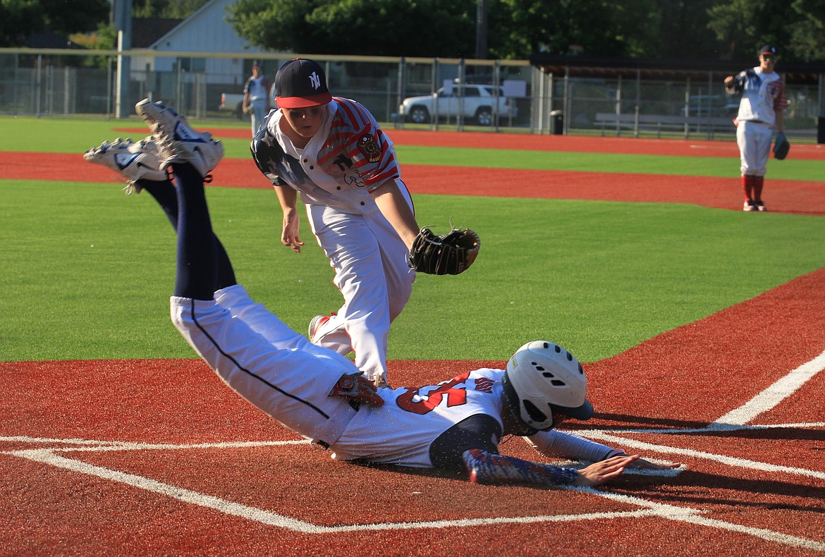 Noah Benner of the 16U North Idaho Lakers looks to tag out Medical Lake's Zach Boyd as he attempts to steal home on Monday at War Memorial Field.