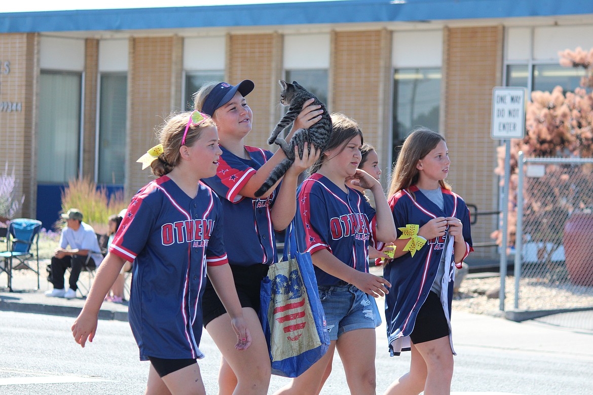 A group of Othello softball players who walked in the July 4 parade brought along a friend for company.