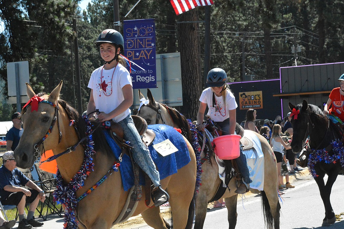 Teagan Frawley leads a trio of red white and blue horses at the Fourth of July Parade. (Amy Quinlivan/Mineral Independent)