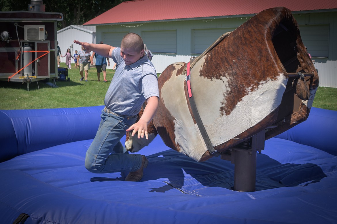 14-year-old Plains resident Utah Butler ends his time on the mechanical bull. (Tracy Scott/Valley Press)