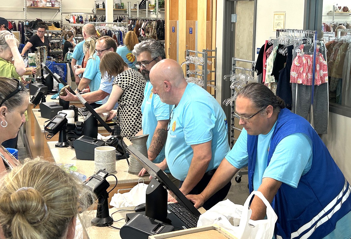 Goodwill staff line up to help customers on Monday.