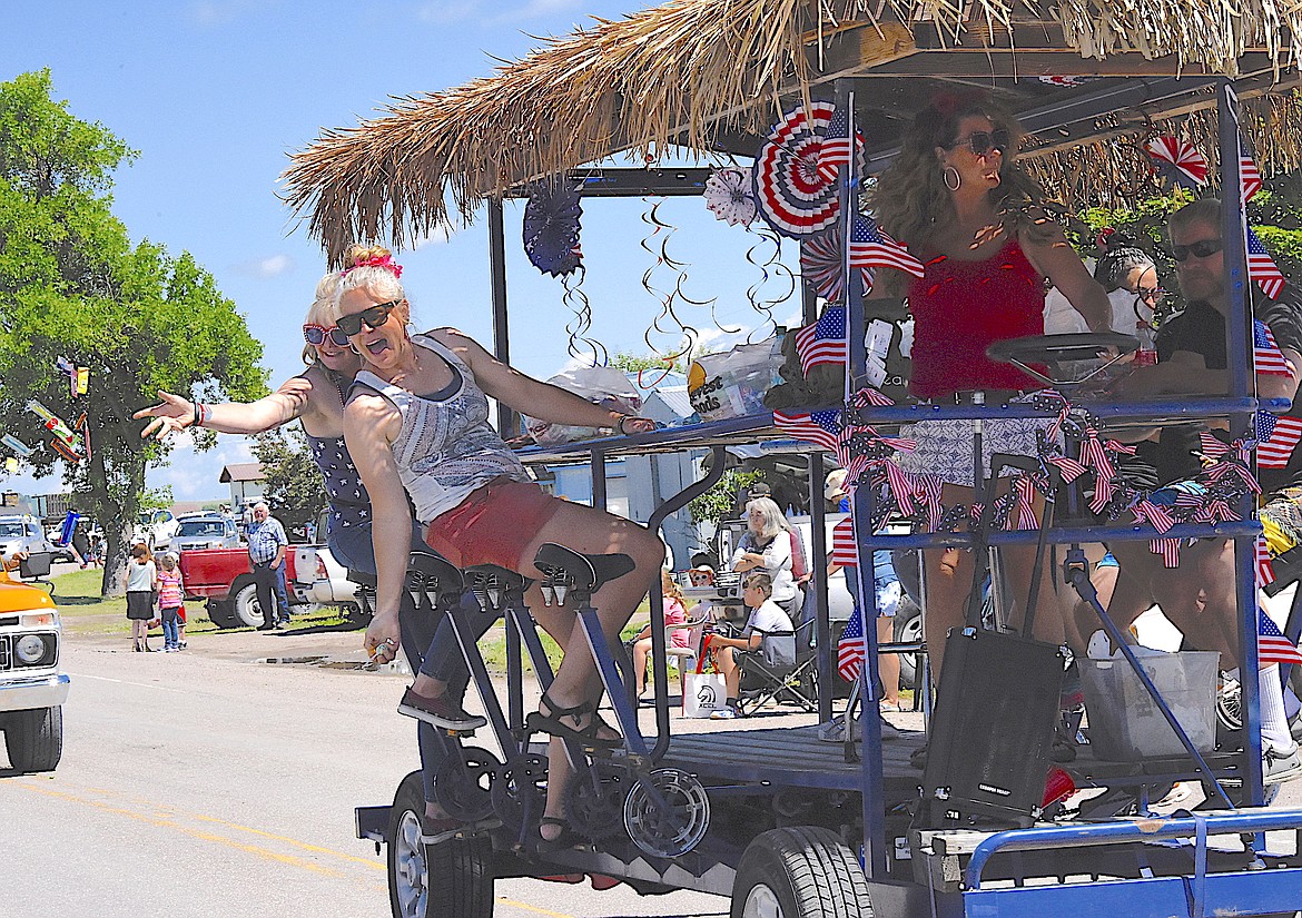 Ladies on the tiki pedal car were throwing candy to kids (of all ages) along Charlo's Main Street during the Fourth of July Parade. (Berl Tiskus/Leader)