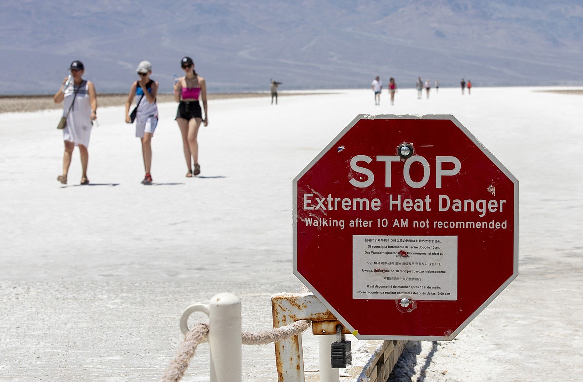 A stop sign warns tourists of extreme heat at Badwater Basin, Monday, July 8, 2024, in Death Valley National Park, Calif. (Daniel Jacobi II/Las Vegas Review-Journal via AP)