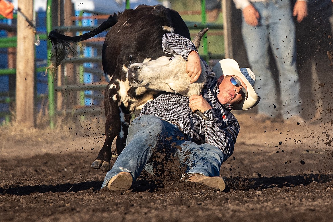 Bart Slaney of Whitefish steer wrestles on Friday. (Avery Howe/Bigfork Eagle)