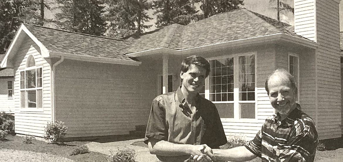 North Idaho College spokesman Steve Schenk hands keys to the Really BIG Raffle house to Pat Reagan.