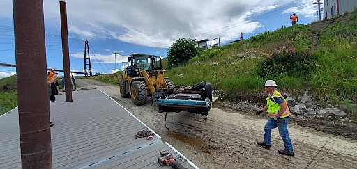 Goodfellow Bros. Foreman Dave Swansen and Tracey Sines move the car body from the boat ramp to the parking lot so it can be hauled for scrap.