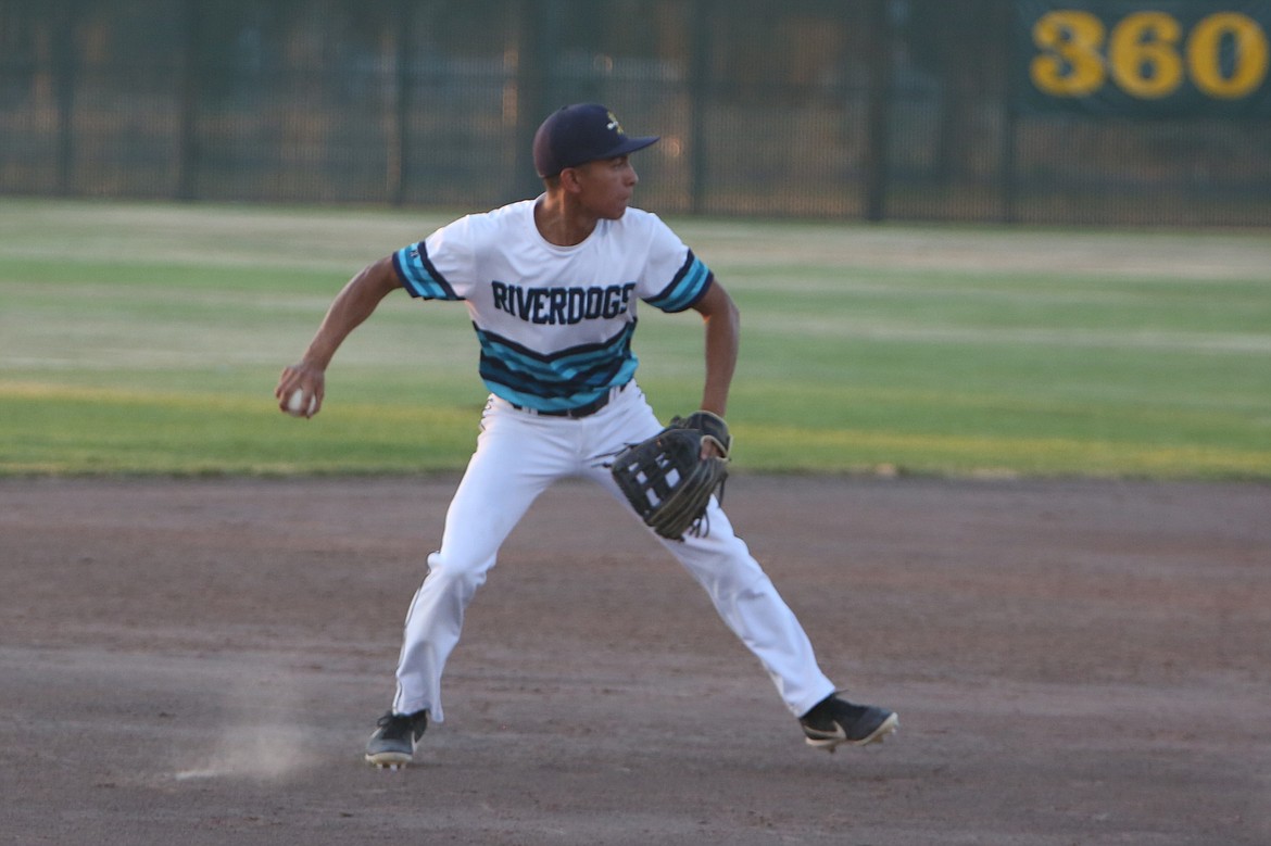 River Dog shortstop Javier Flores picks up a ground ball and throws it back to first base during the nightcap of Tuesday’s doubleheader against Othello.