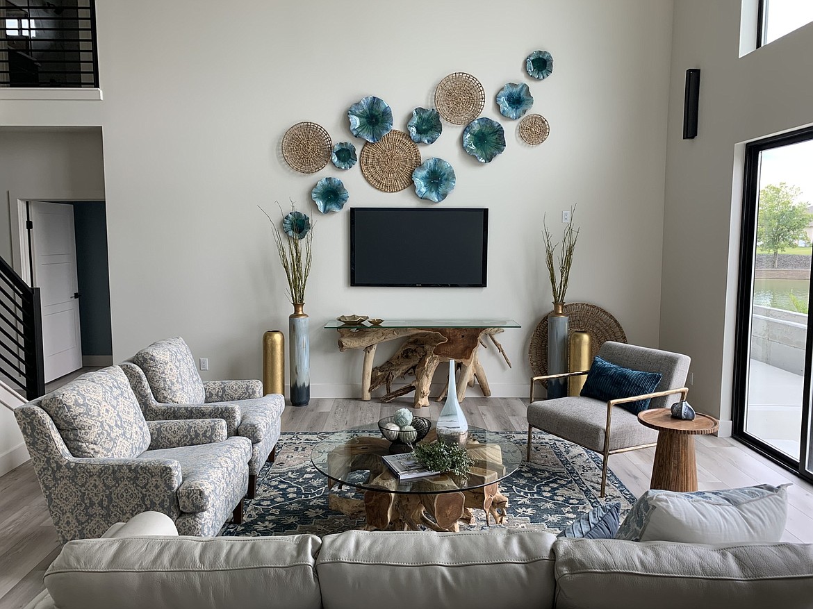 A well-designed space isn’t just comfortable and functional, it’s visually appealing with coordinated colors and spaces set up to serve the needs of the person living in the home. In this living room, the television can be easily viewed but the space around the coffee table makes it easy for people to converse.