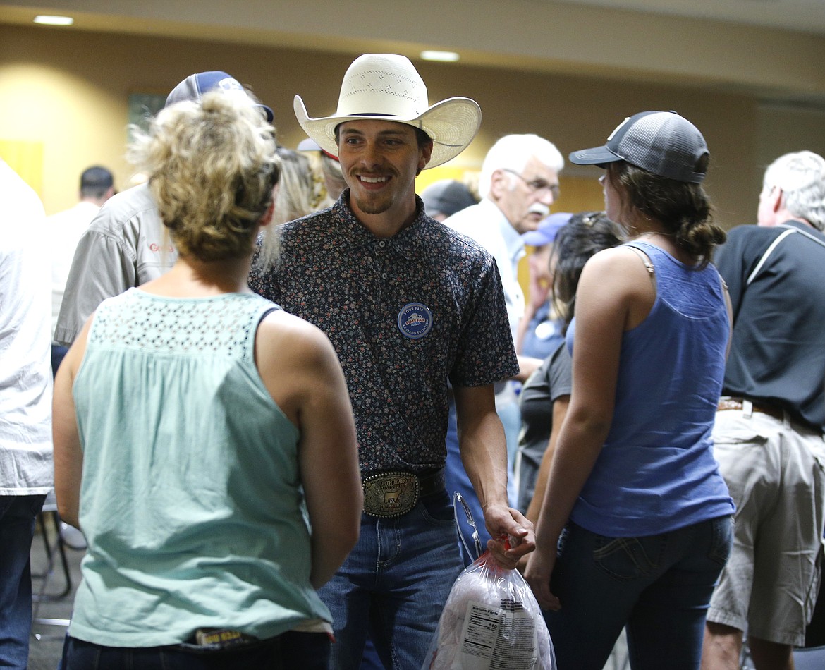 A volunteer hands out cotton candy to town hall attendees.