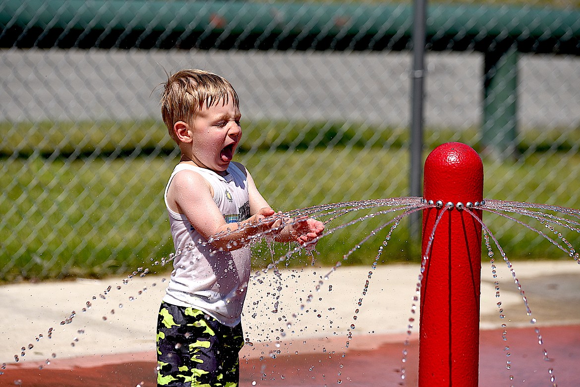 Calum Zimmerman enjoys the splash pad at Fireman Memorial Park Wednesday, July 10, 2024, in Libby. (Scott Shindledecker/The Western News)