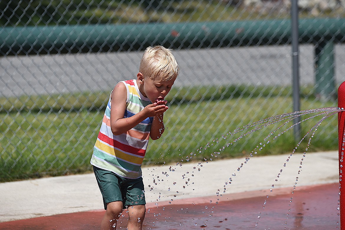 Lucien Spencer enjoys the splash pad at Fireman Memorial Park Wednesday, July 10, 2024, in Libby. (Scott Shindledecker/The Western News)