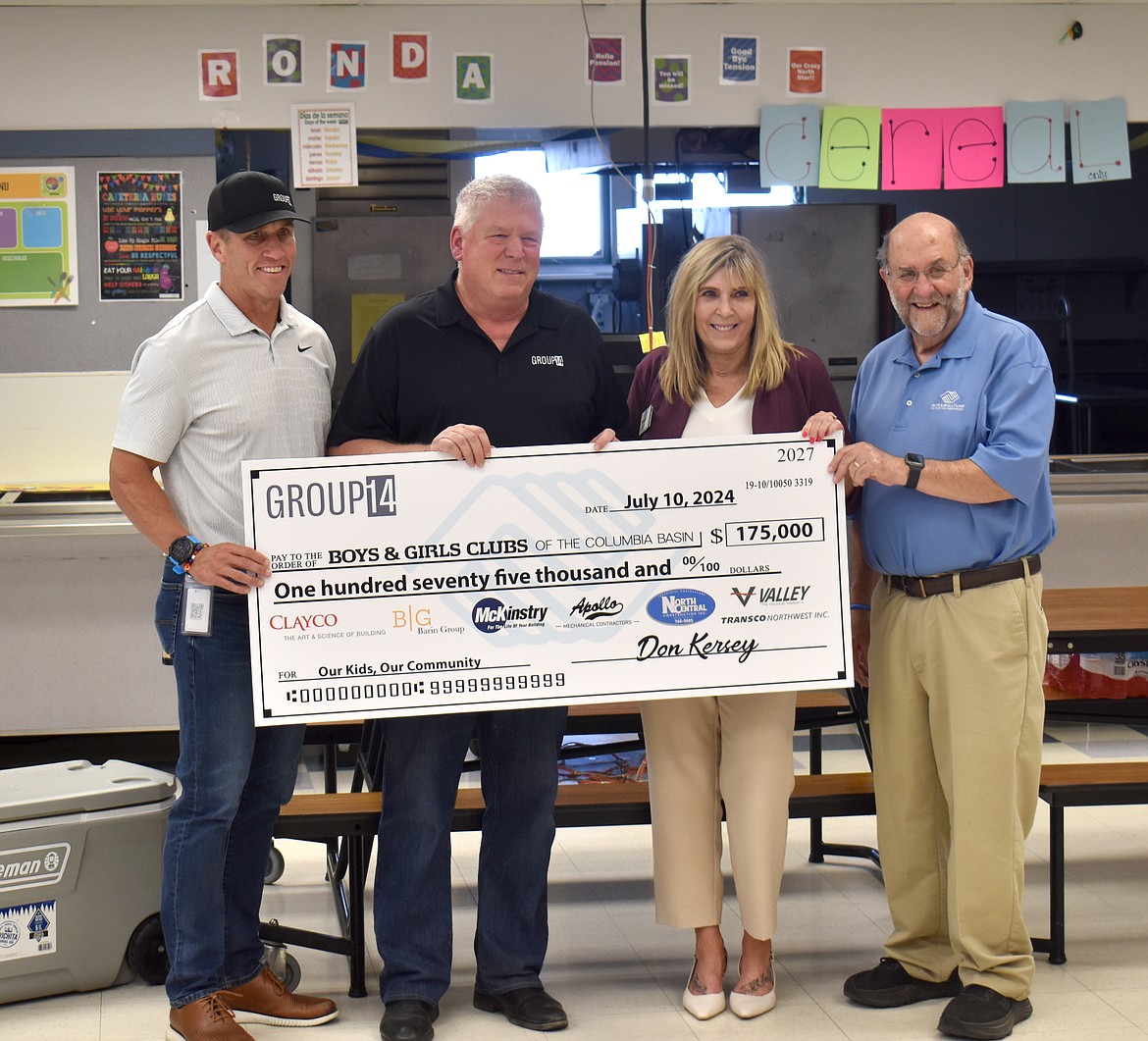 From left: Group14 Vice President of Major Projects and Planning Matt Laccinole and Plant Manager Don Kersey hand a check for $175,000 to Boys and Girls Clubs of the Columbia Basin CEO Kim Pope and Board President P.J. DeBenedetti. The money, raised by Group14 and its construction partners, is enough to keep the club running through the end of 2024.