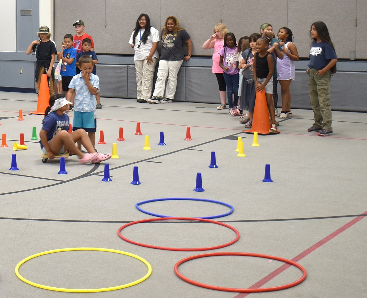 Students in the Boys & Girls Club summer program at North Elementary demonstrated an obstacle course that includes riding a scooter board blindfolded, hopping through hula hoops and shooting baskets.