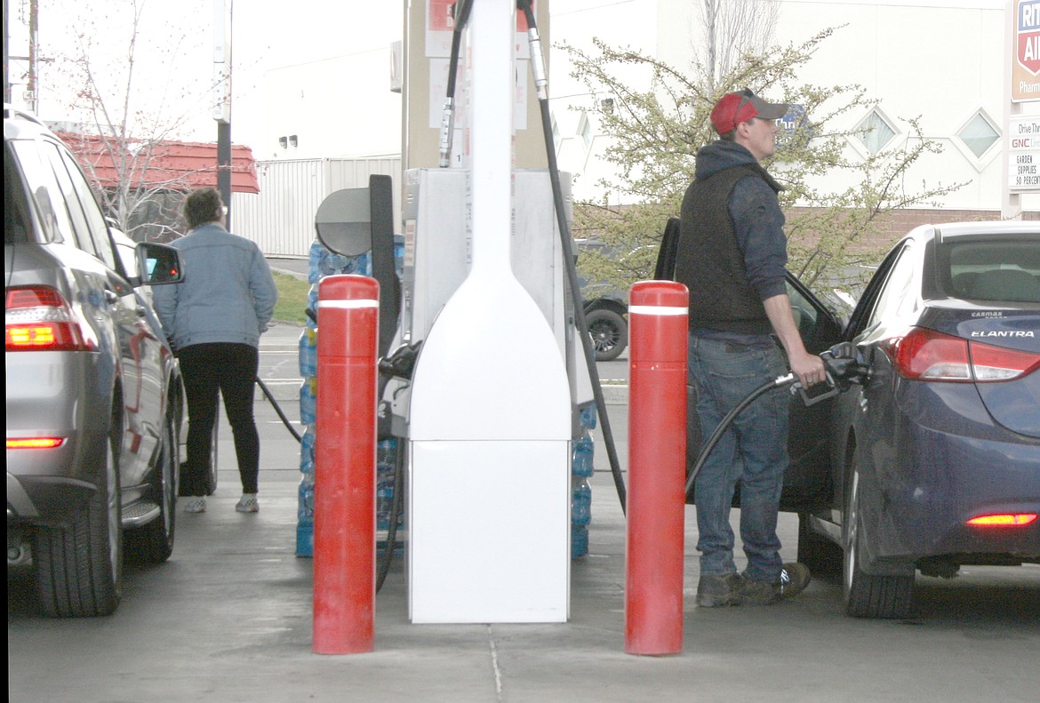 Drivers fill their tanks at a Moses Lake gas station. Fuel prices have dropped in Washington at the third-highest rate in the country, according to a recent study.