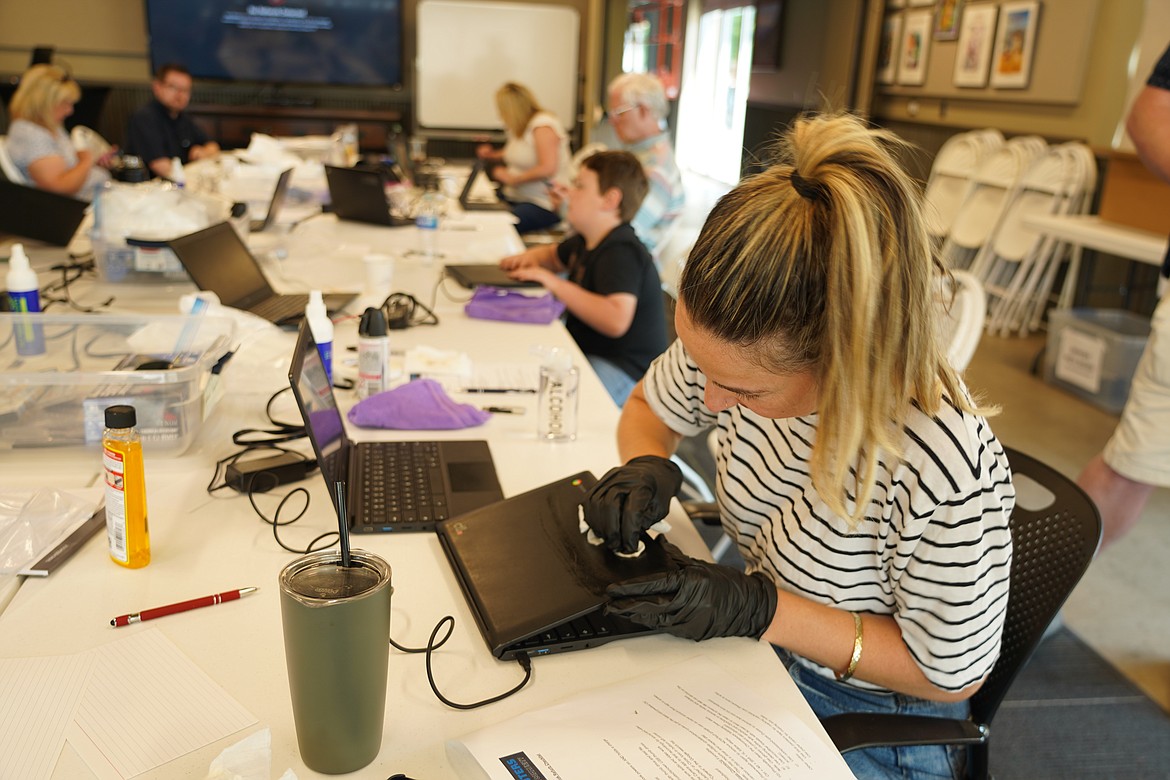 Sarah Sanford from NCW Tech Alliance and other volunteers work on refurbishing donated equipment to provide to those who need them to access digital services like health care, banking and education. The nonprofit accepts donations and welcomes volunteers who they will train to set up the equipment.