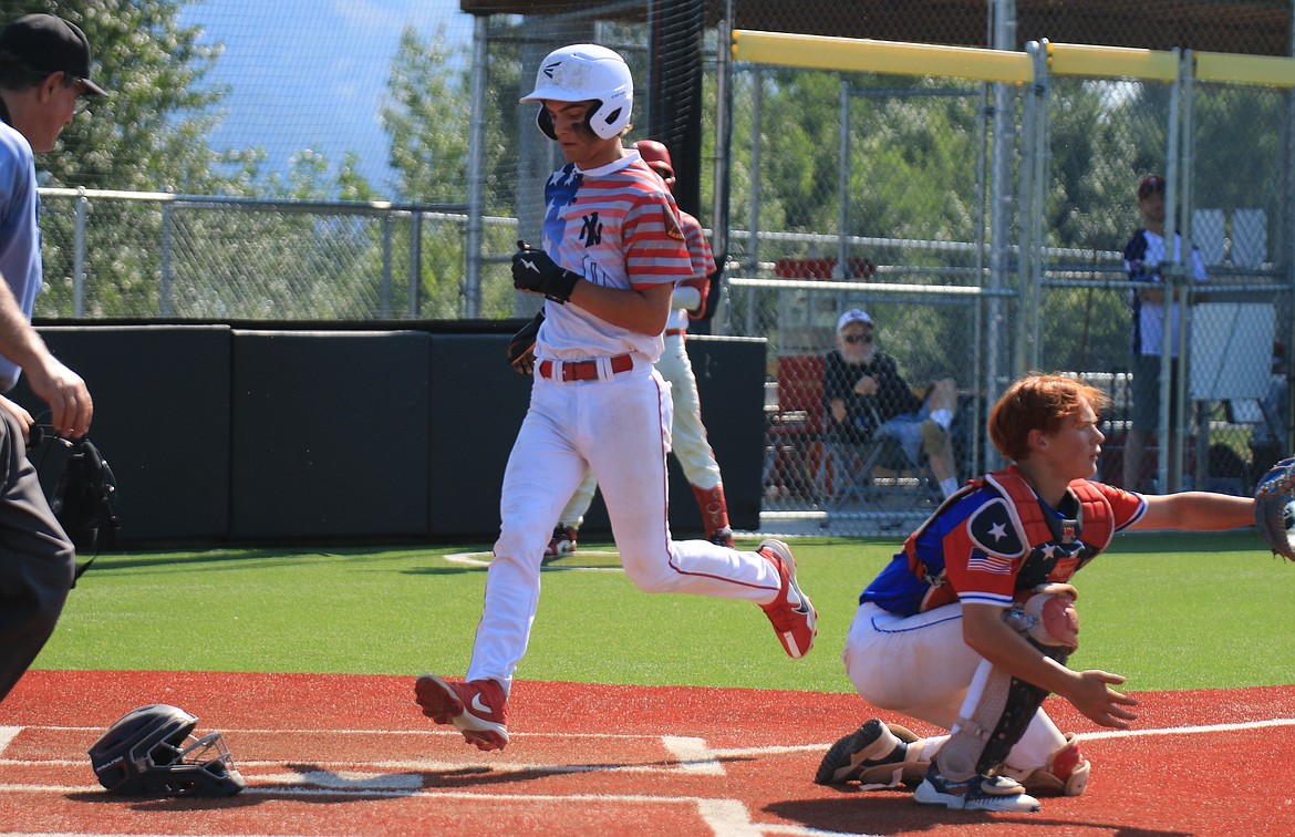 Soren Caprio tags up from third base to score during the second game against Orofino.