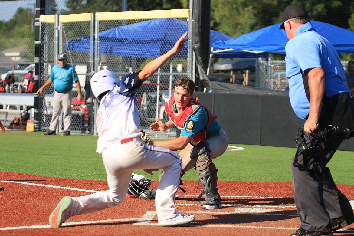 Cole Sanroman attempts to beat out Camas Prairie catcher Thayn Williams during the first game on Saturday.