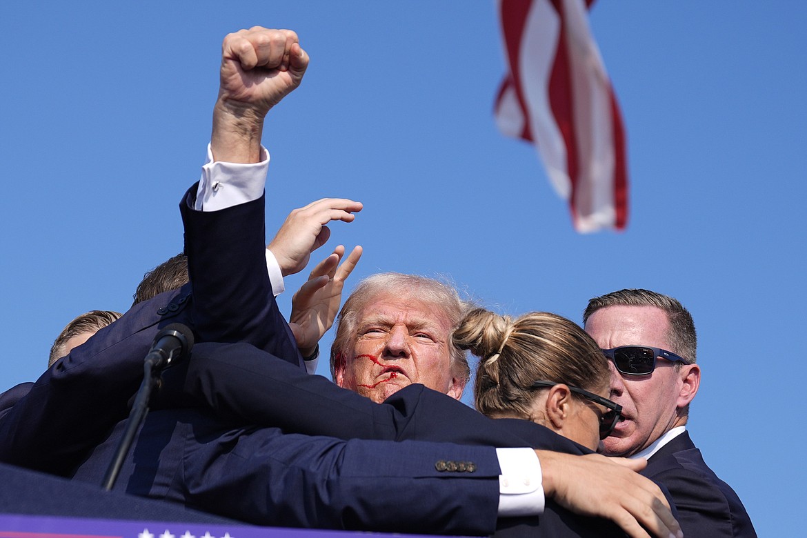 Republican presidential candidate former President Donald Trump is surrounded by U.S. Secret Service agents at a campaign rally, Saturday, July 13, 2024, in Butler, Pa. (AP Photo/Evan Vucci)