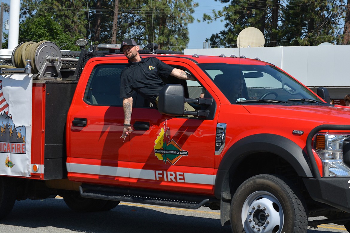 Candy is pitched from a Idaho Department of Lands vehicle during the Post Falls parade.