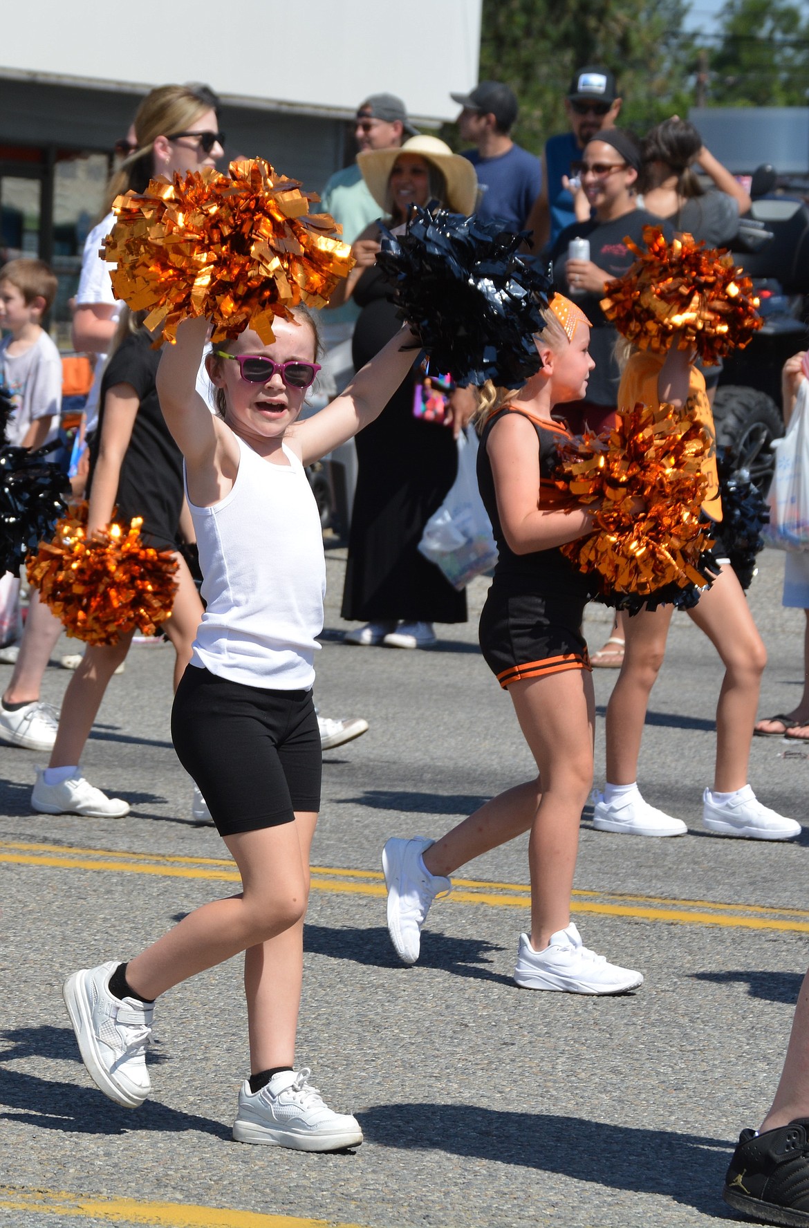 Post Falls Jr. Tackle and Cheer make their way from North Frederick St. and Seltice Way to Idaho St. during the Post falls parade Saturday.