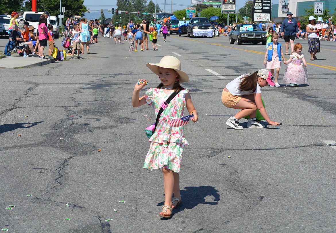 Abbi Young shows her mom, Erin Young, the handful of candy she's collected.