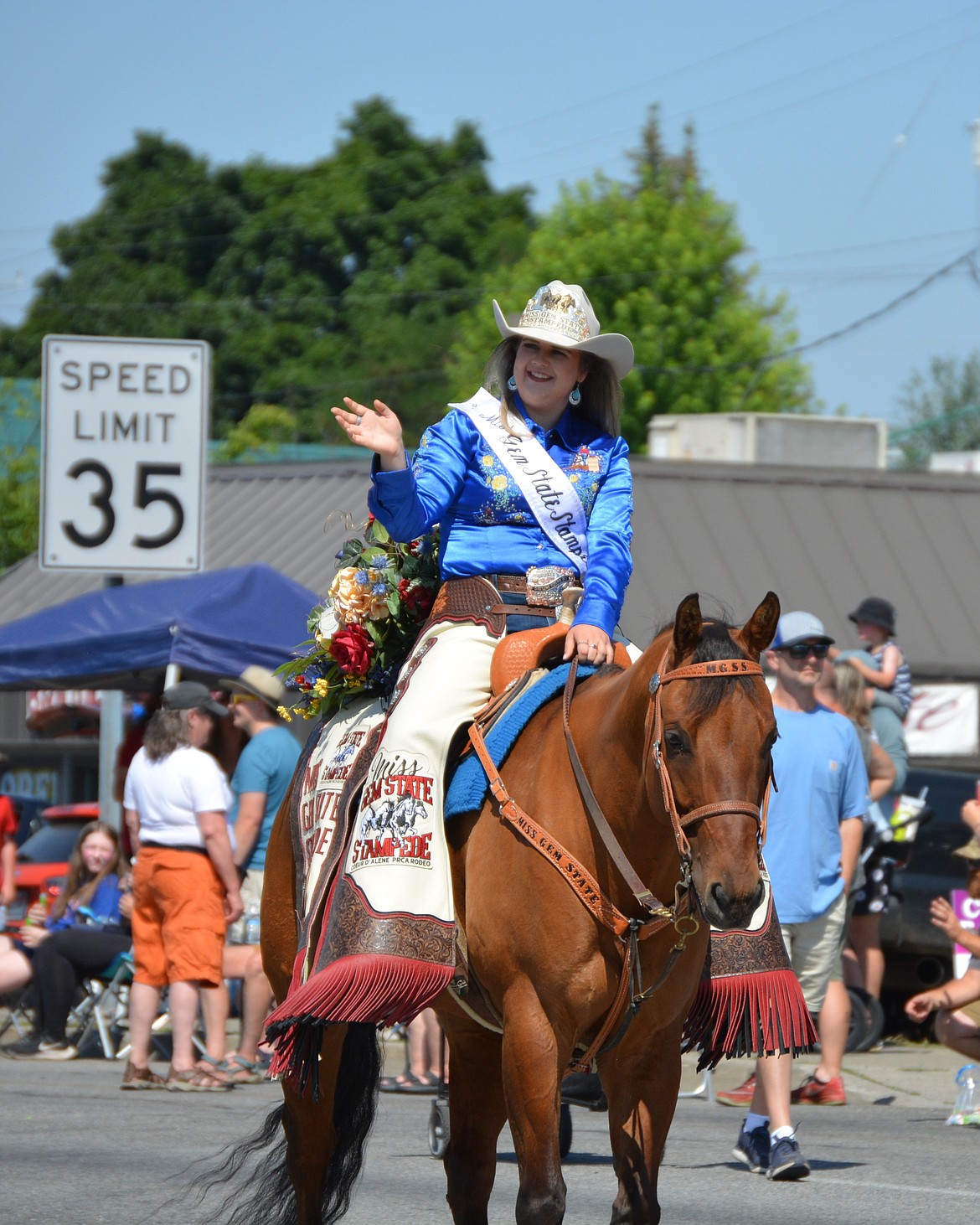 Ainsley Goughnour, this year's Miss Gem State Stampede, rides her horse in the Post Falls parade.