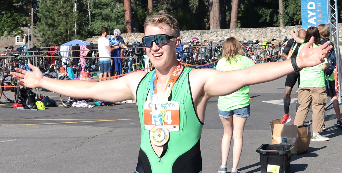 Jaxon Jorgensen of Post Falls starts to celebrate after finishing the Hayden Triathlon on Saturday. The 26-year-old finished 21st in 1:21:31 and second in his age group.