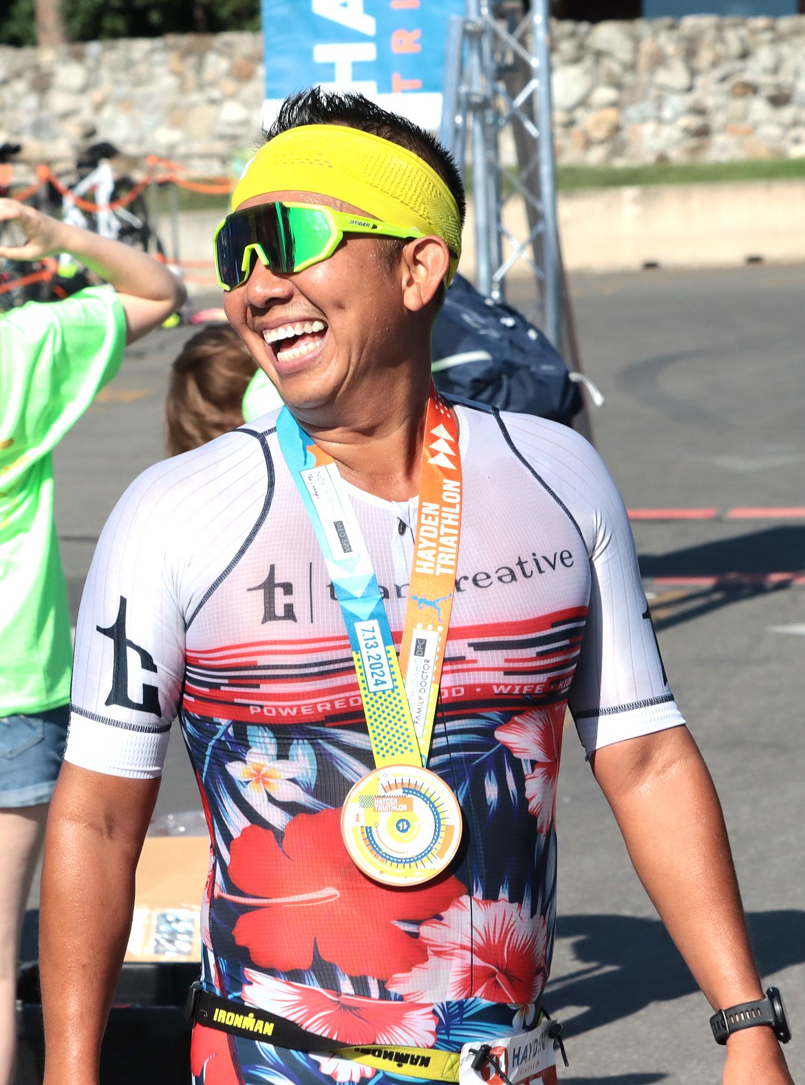 Ben Tran of Coeur d'Alene smiles at the finish line of the Hayden Triathlon on Saturday. He placed 25 in 1:21:54