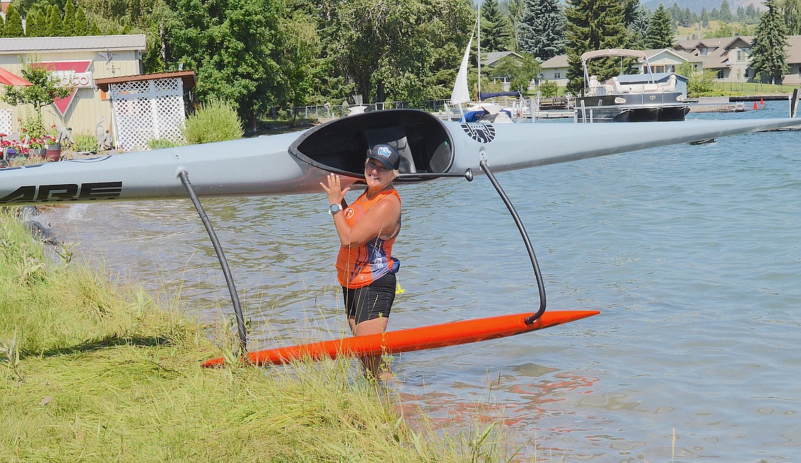 Proud paddler Betty Welch from Kansas City hefts her outrigger canoe at the end of a three-hour clinic Sunday in Big Arm. (Kristi Niemeyer/Leader)