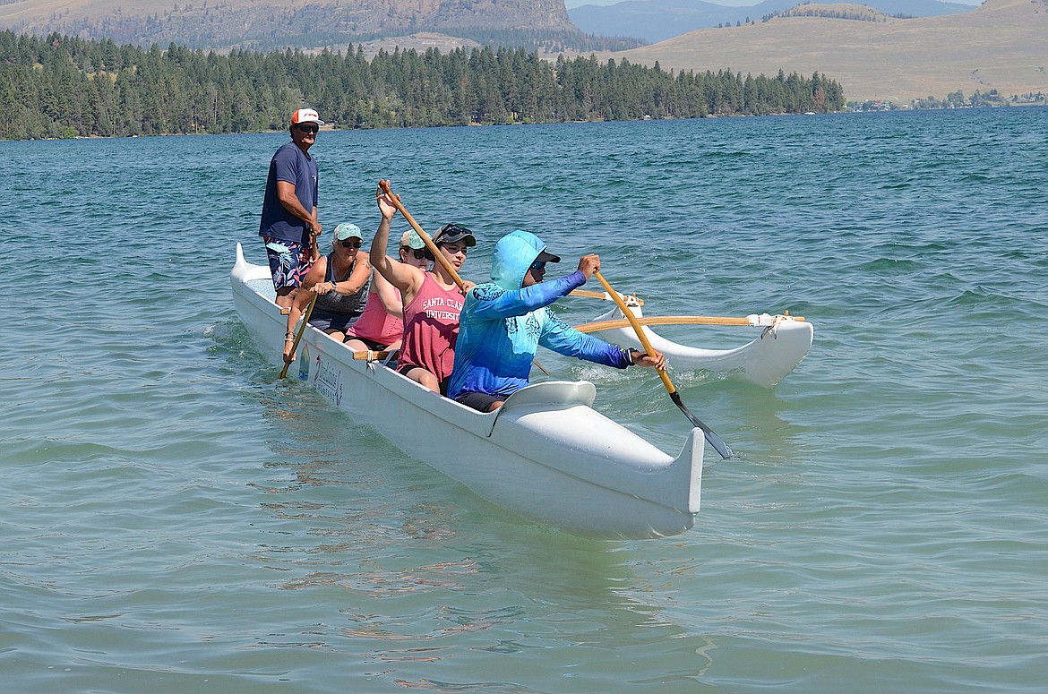 Coach Lewis Laughlin keeps an eye on novice outrigger canoeists as the paddle a six-person vessel to shore. (Kristi Niemeyer/Leader)